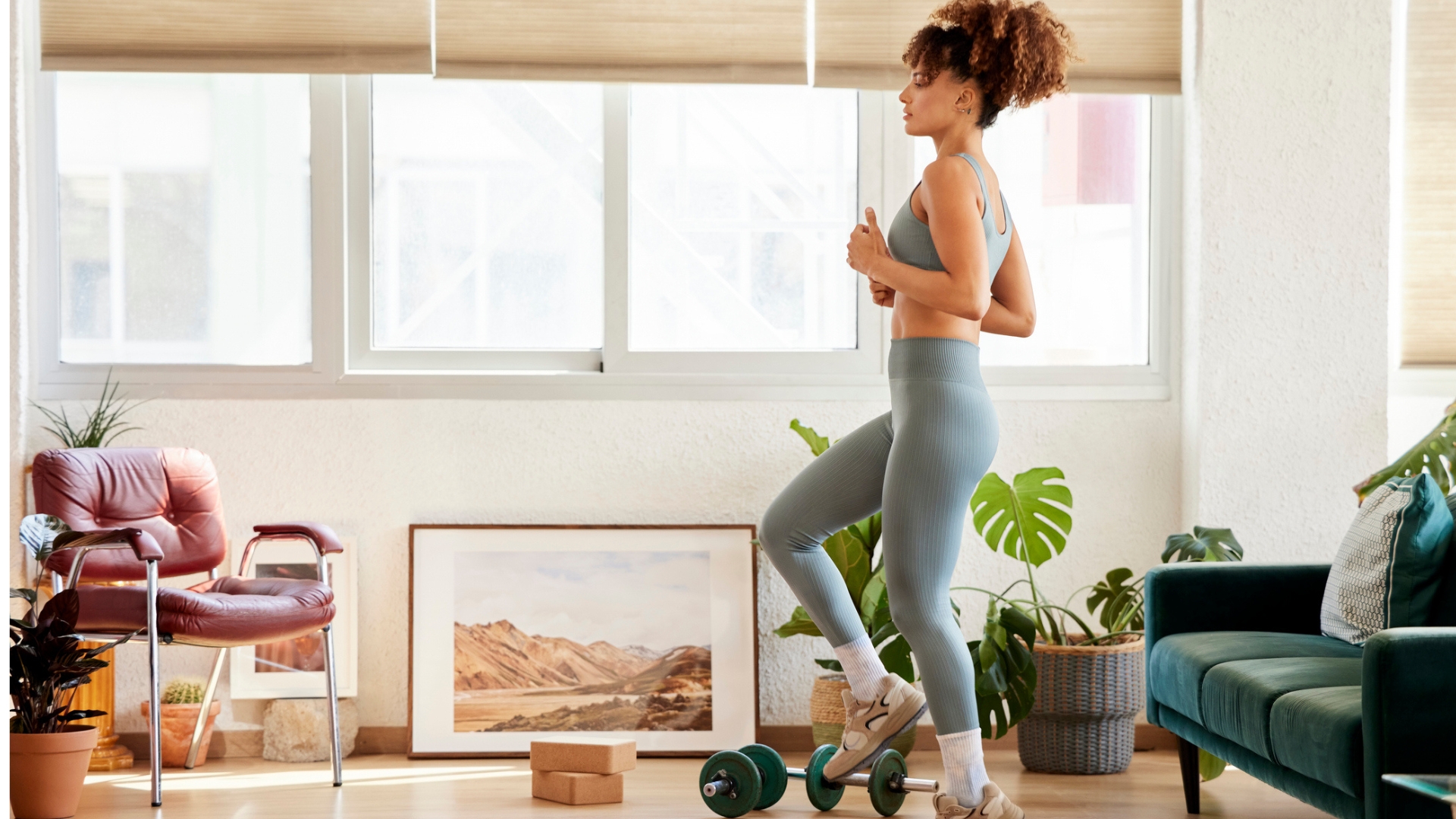 A person doing a brisk indoor walk in a hallway at home, wearing comfortable athletic shoes