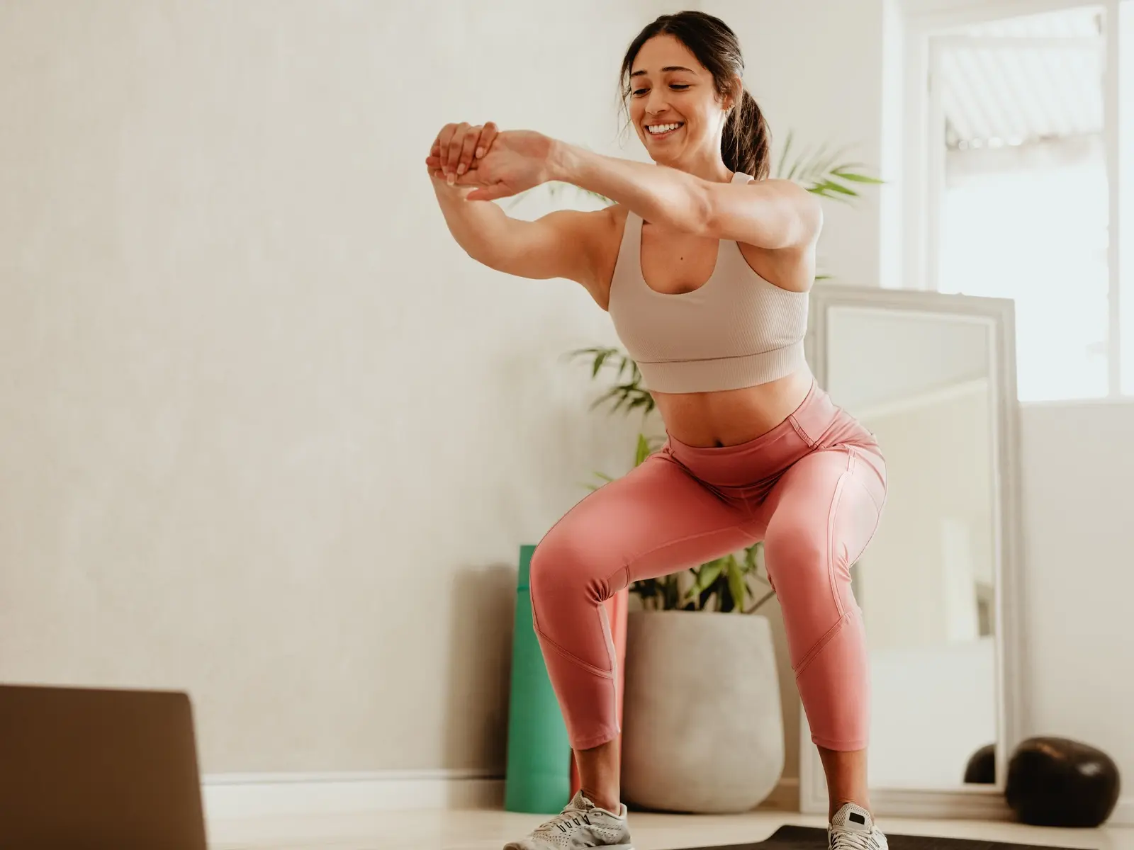 A person standing up from a dining chair with controlled posture, hands hovering near the chair for balance