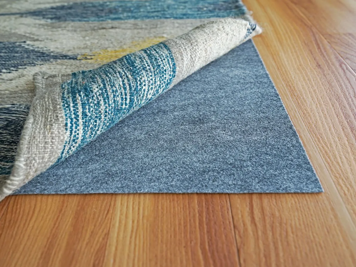 A rug laid over hardwood to create a more stable, quieter workout surface