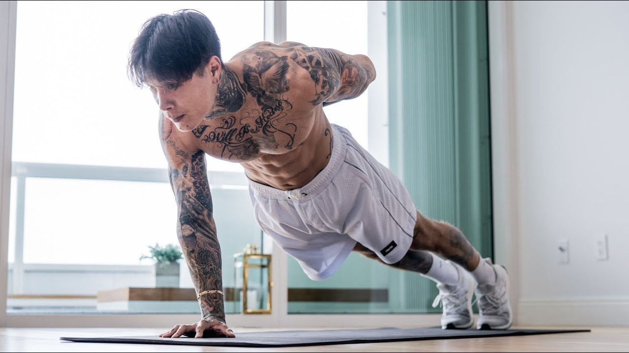 A side view of a person lowering slowly through a push-up with a straight body line, elbows angled back, core braced, and shoulders staying controlled