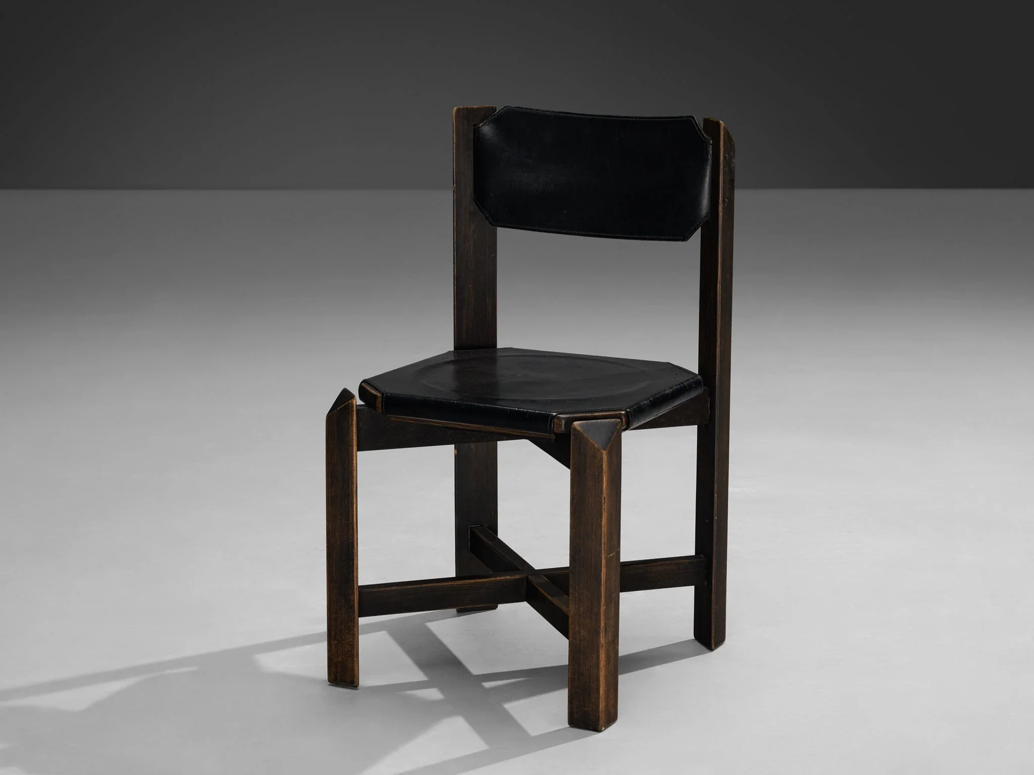 A sturdy dining chair on a flat floor, positioned so it will not slide, ready for chair-tap squats